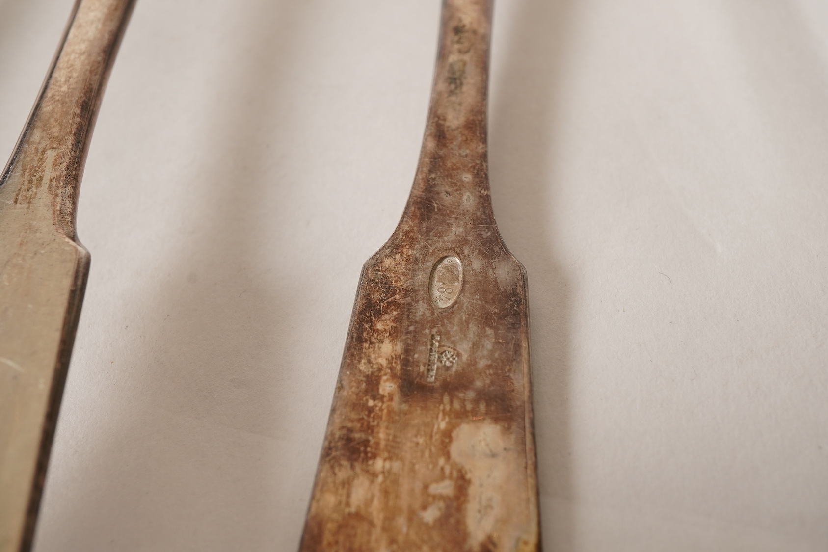 A set of twelve white metal fiddle and shell pattern table forks and five matching dessert forks